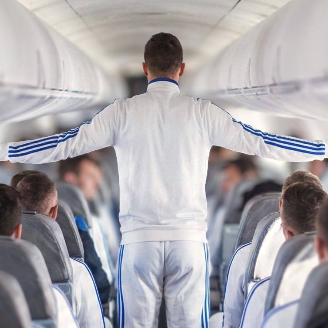 Professional sports team celebrating aboard a chartered commercial aircraft during a team charter flight.